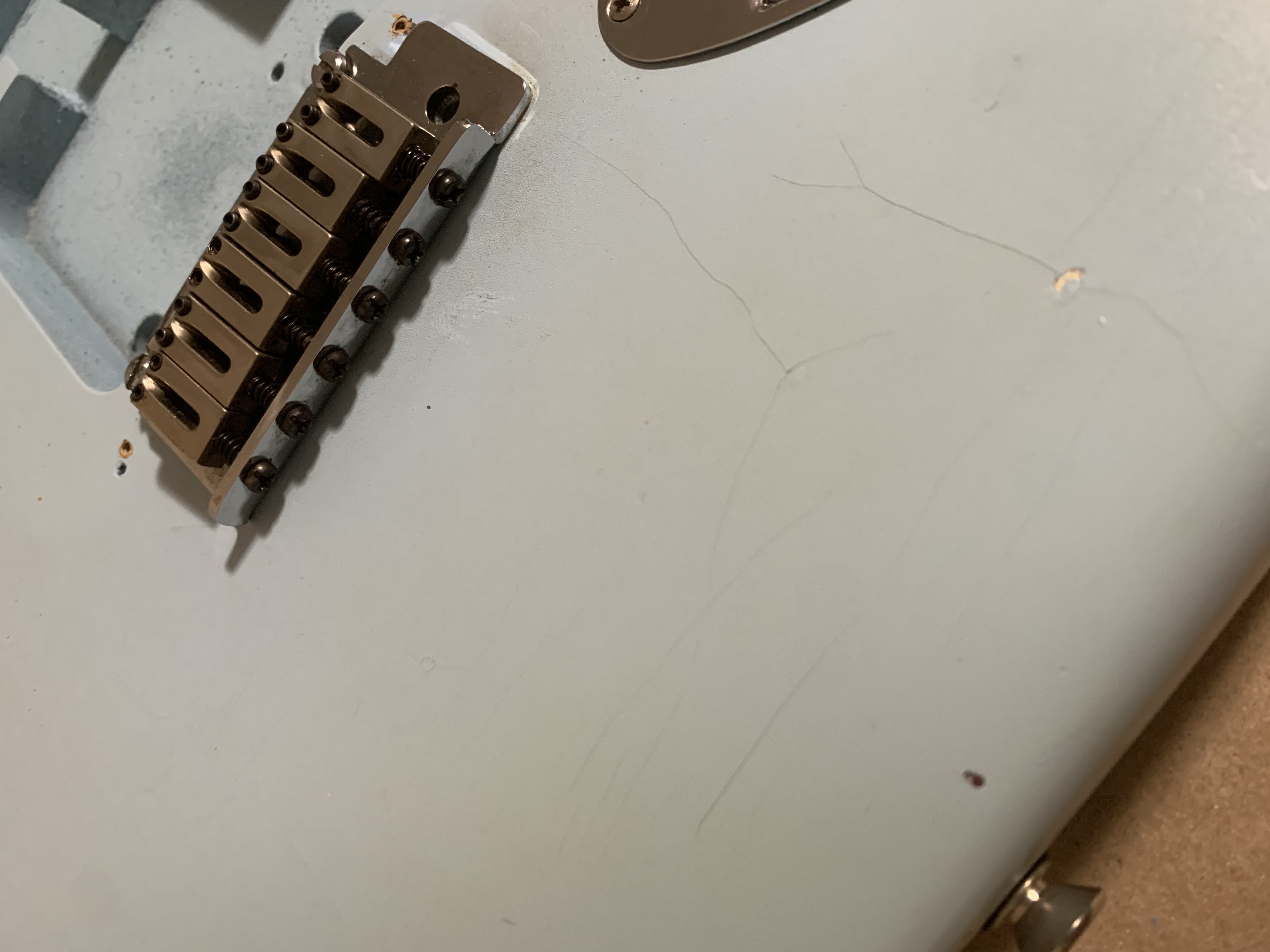 A slightly dismantled guitar on a workbench