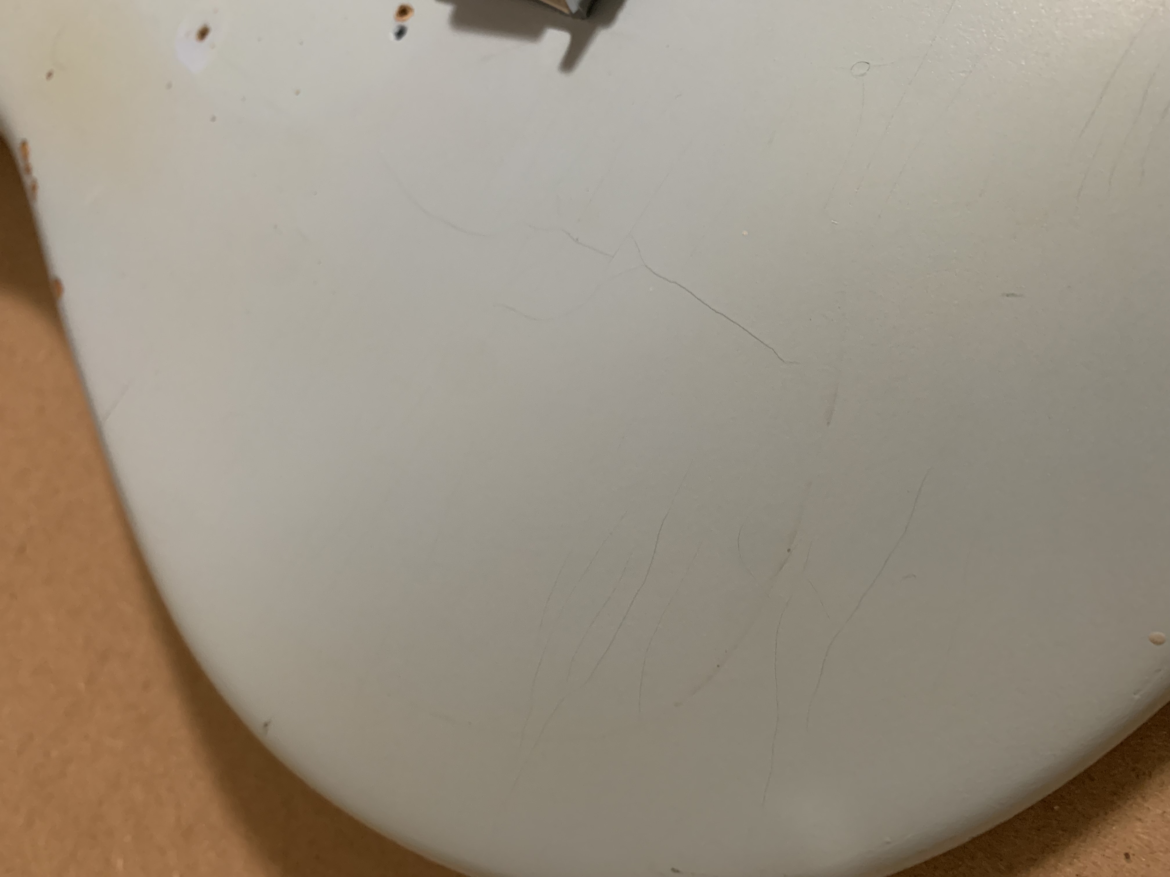 A slightly dismantled guitar on a workbench