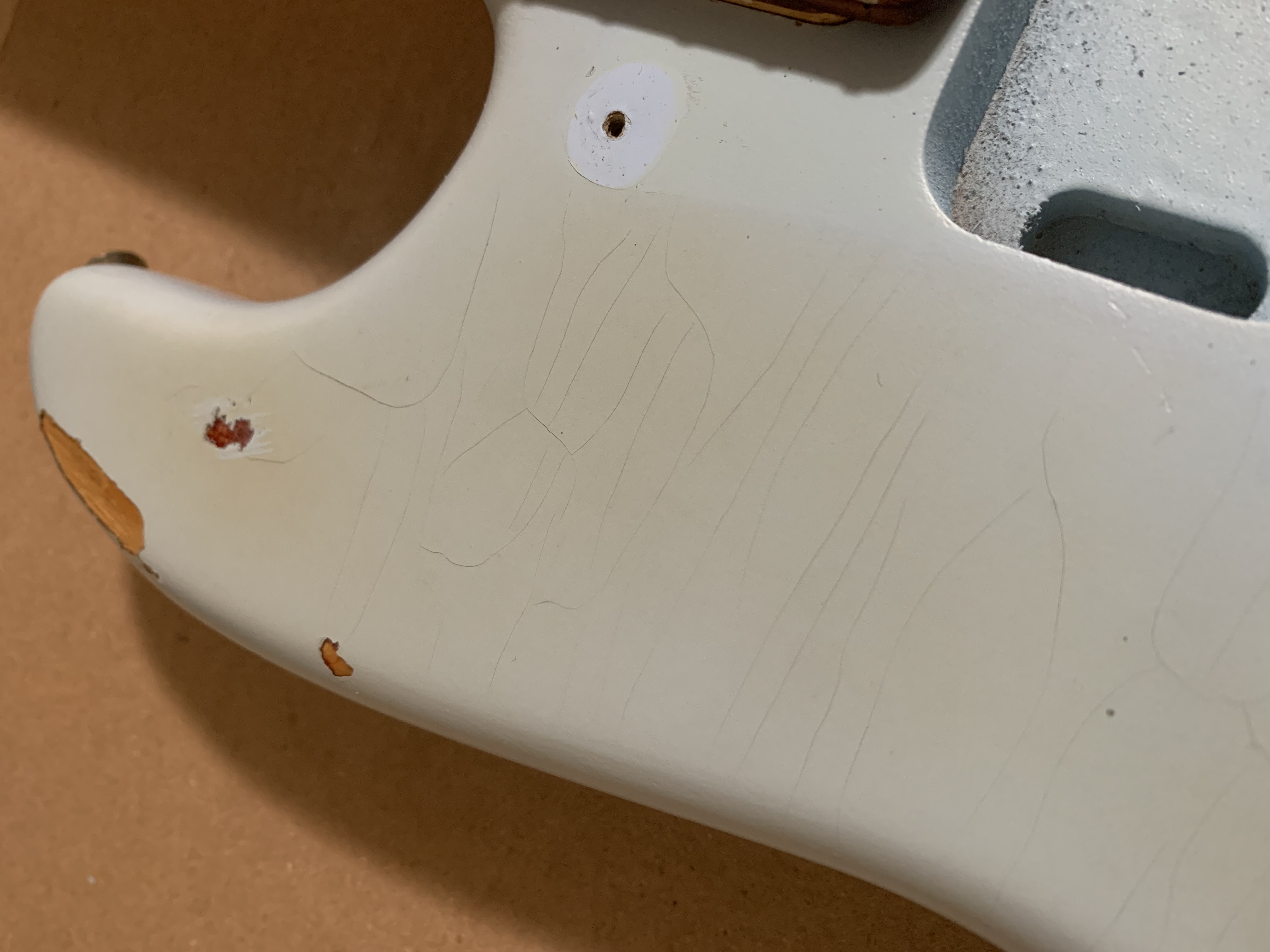 A slightly dismantled guitar on a workbench
