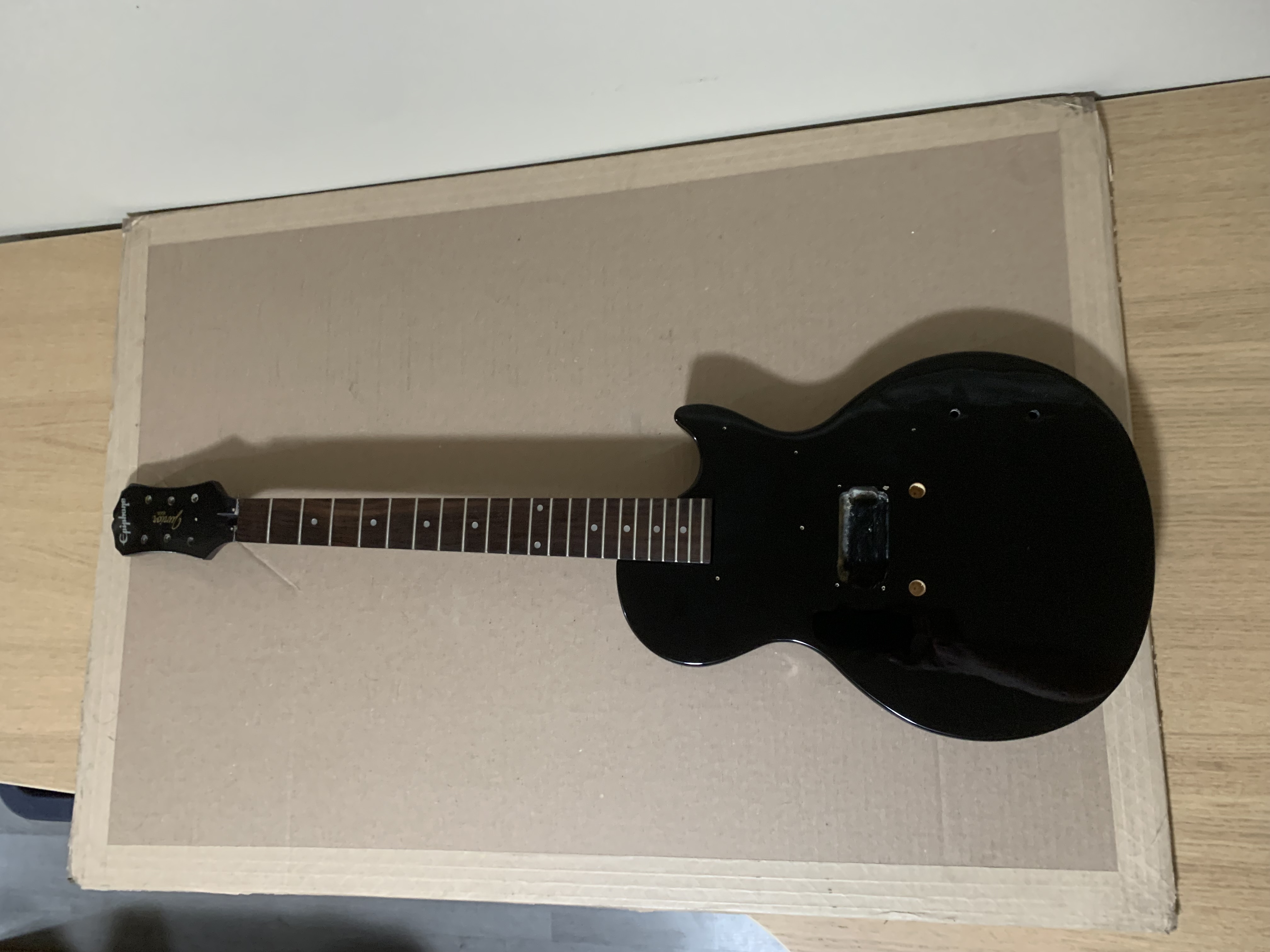 Black guitar on a desk