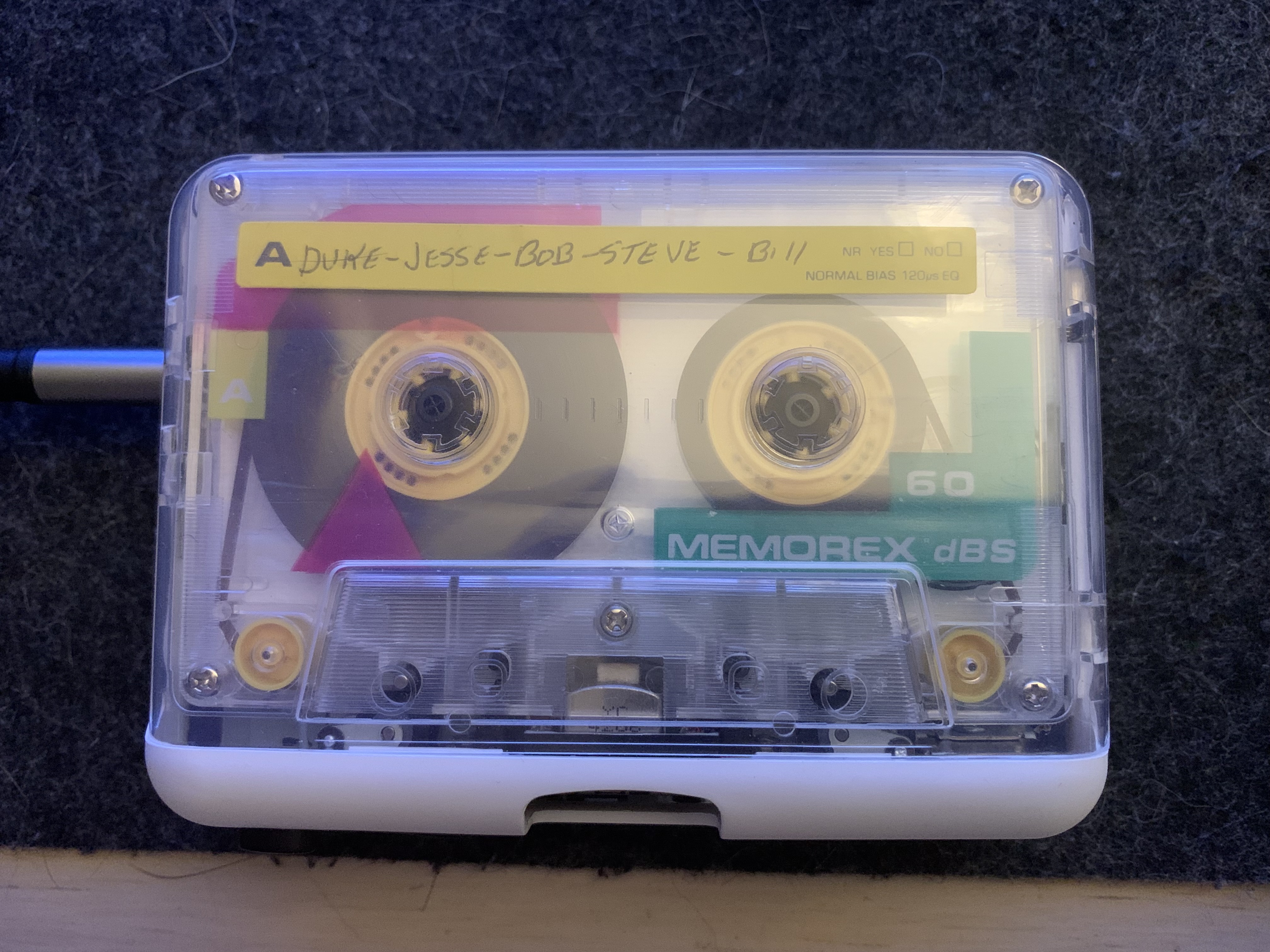 A cassette tape in a tape player on a desk