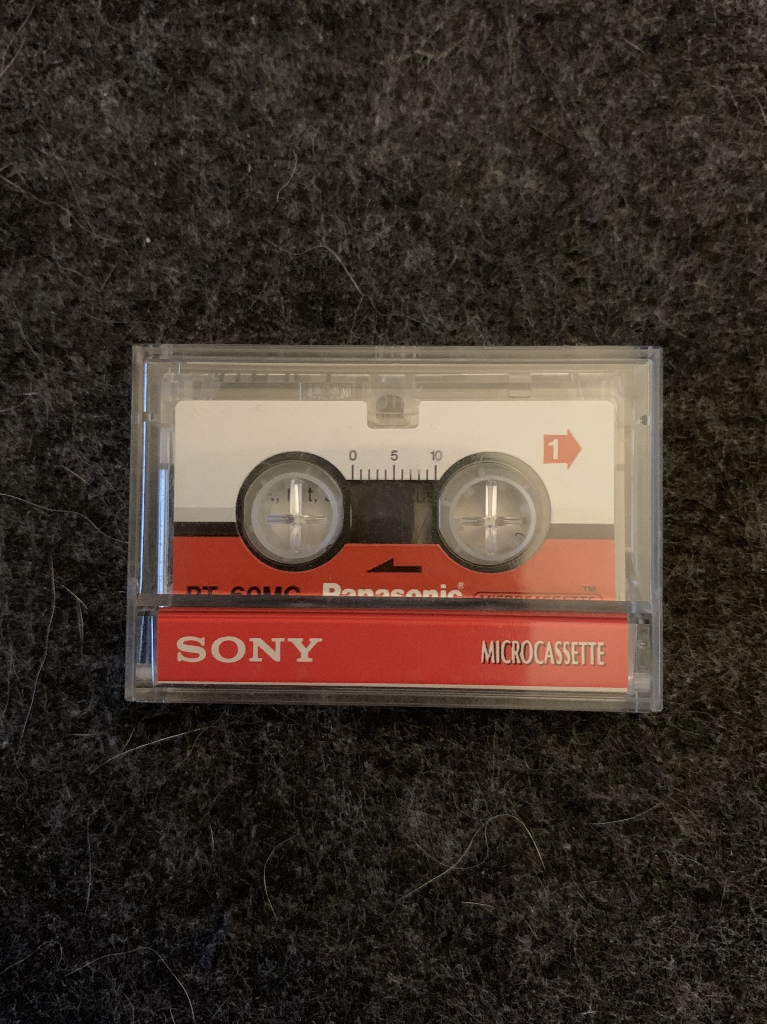 A microcassette sitting on a desk